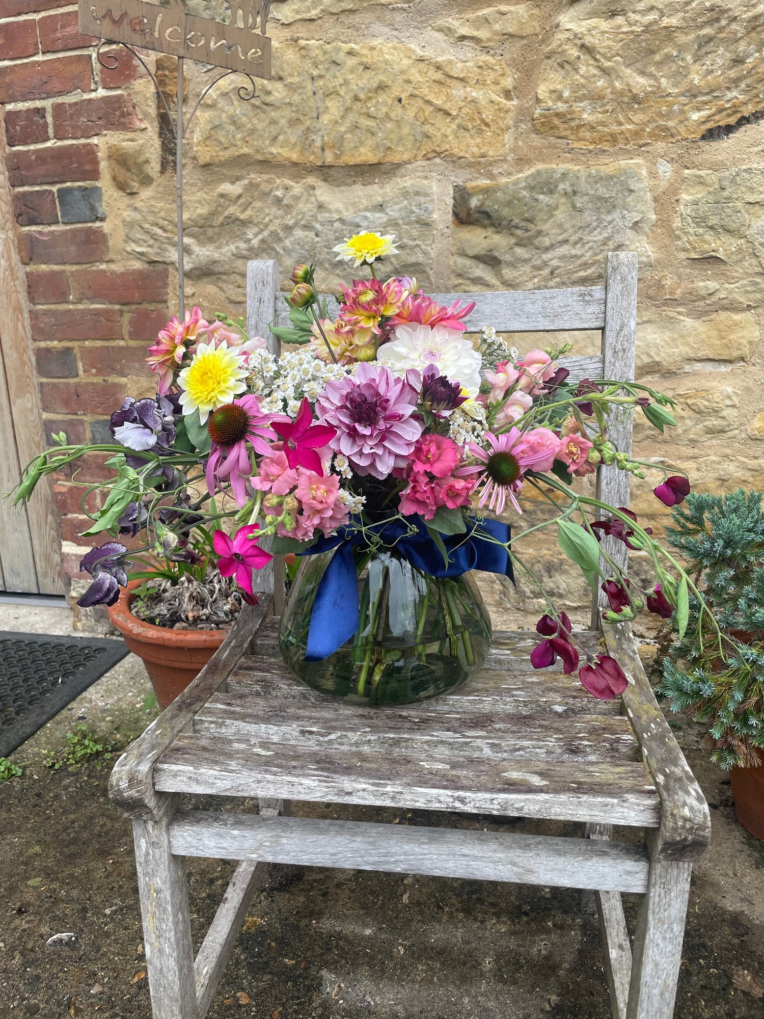 Large vase of flowers on chair