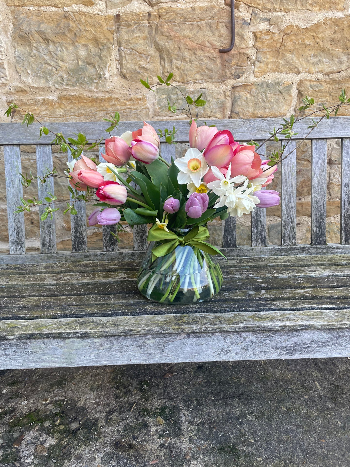 Vase of tulips with green ribbon
