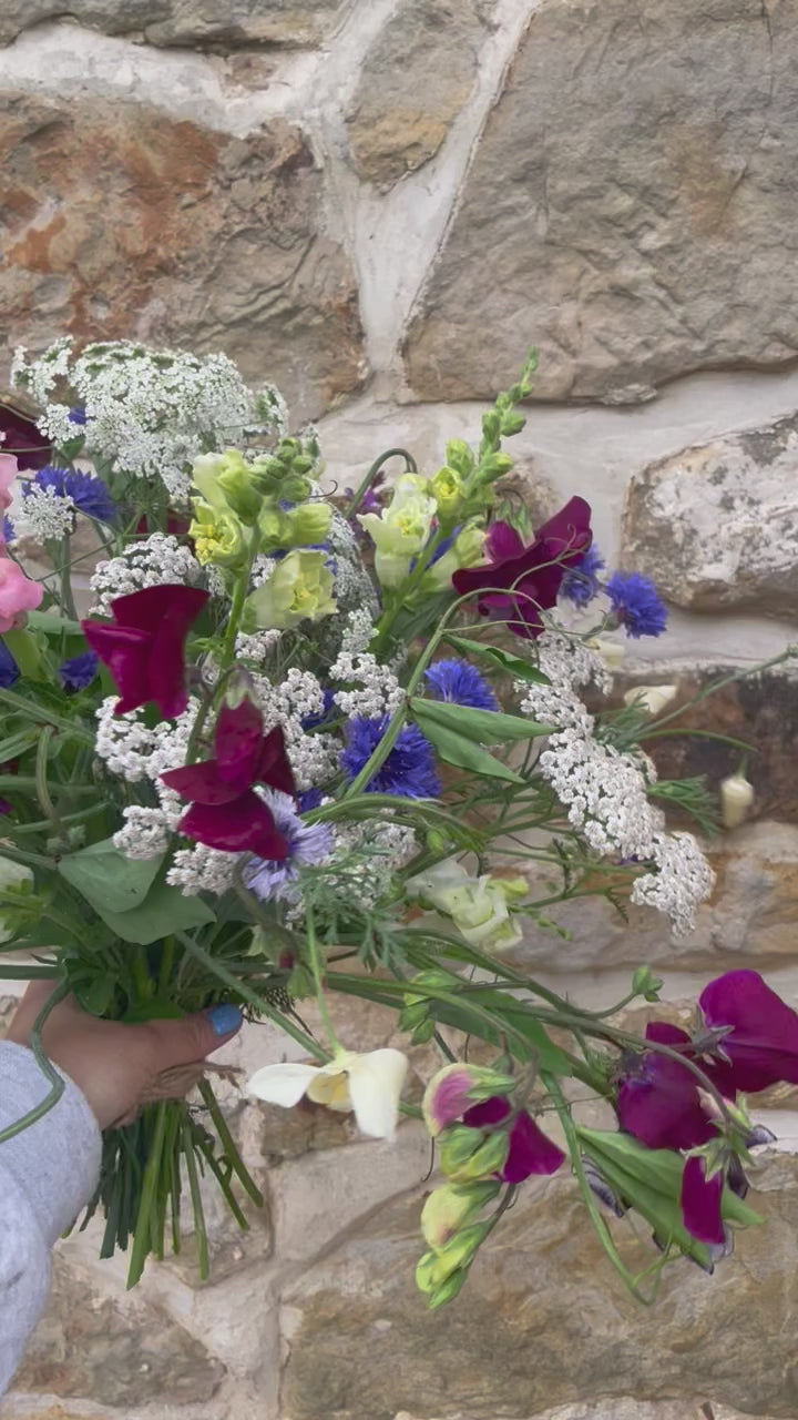 Fresh flower bouquet including cornflowers, achillea and sweet peas